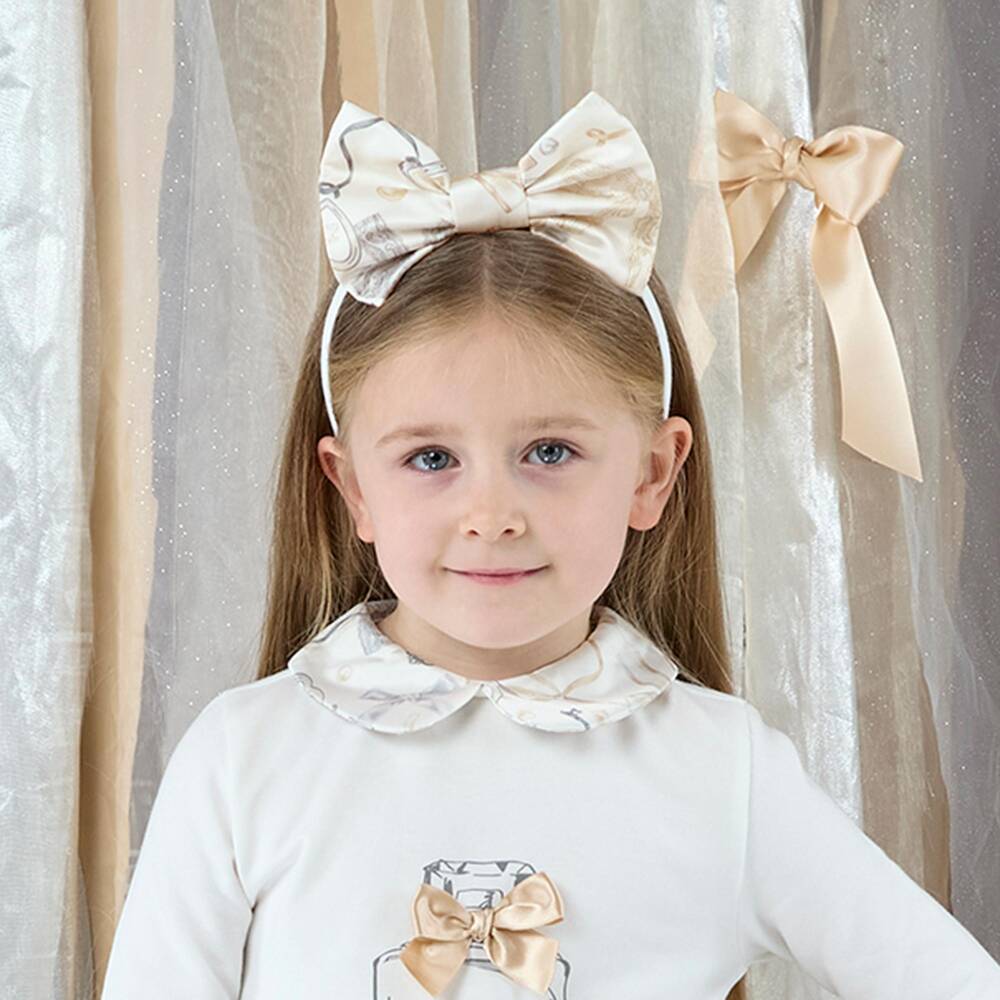 A Dee-Girls Ivory Bow Hairband with a Perfume Bottle Print | Childrensalon