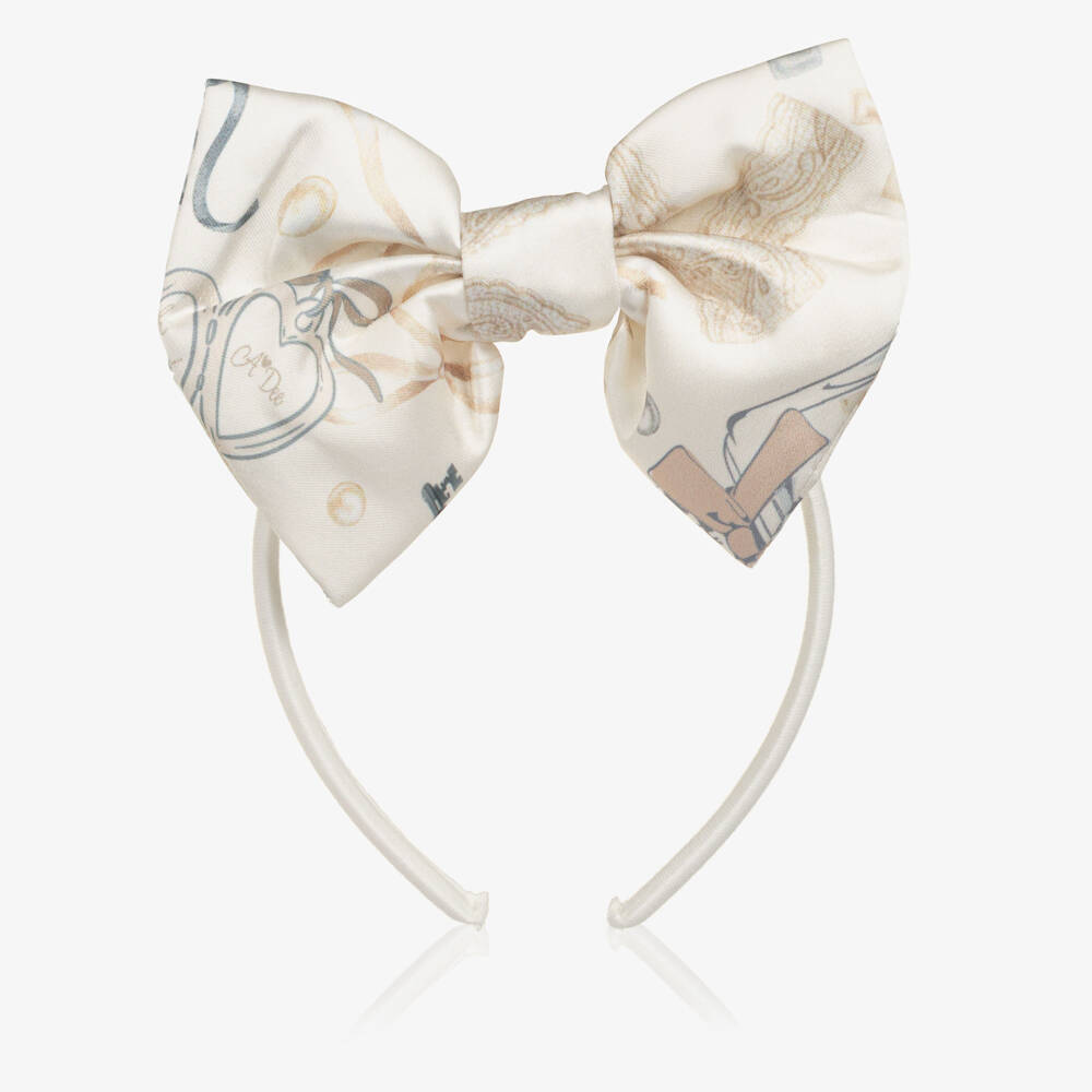 A Dee-Girls Ivory Bow Hairband with a Perfume Bottle Print | Childrensalon
