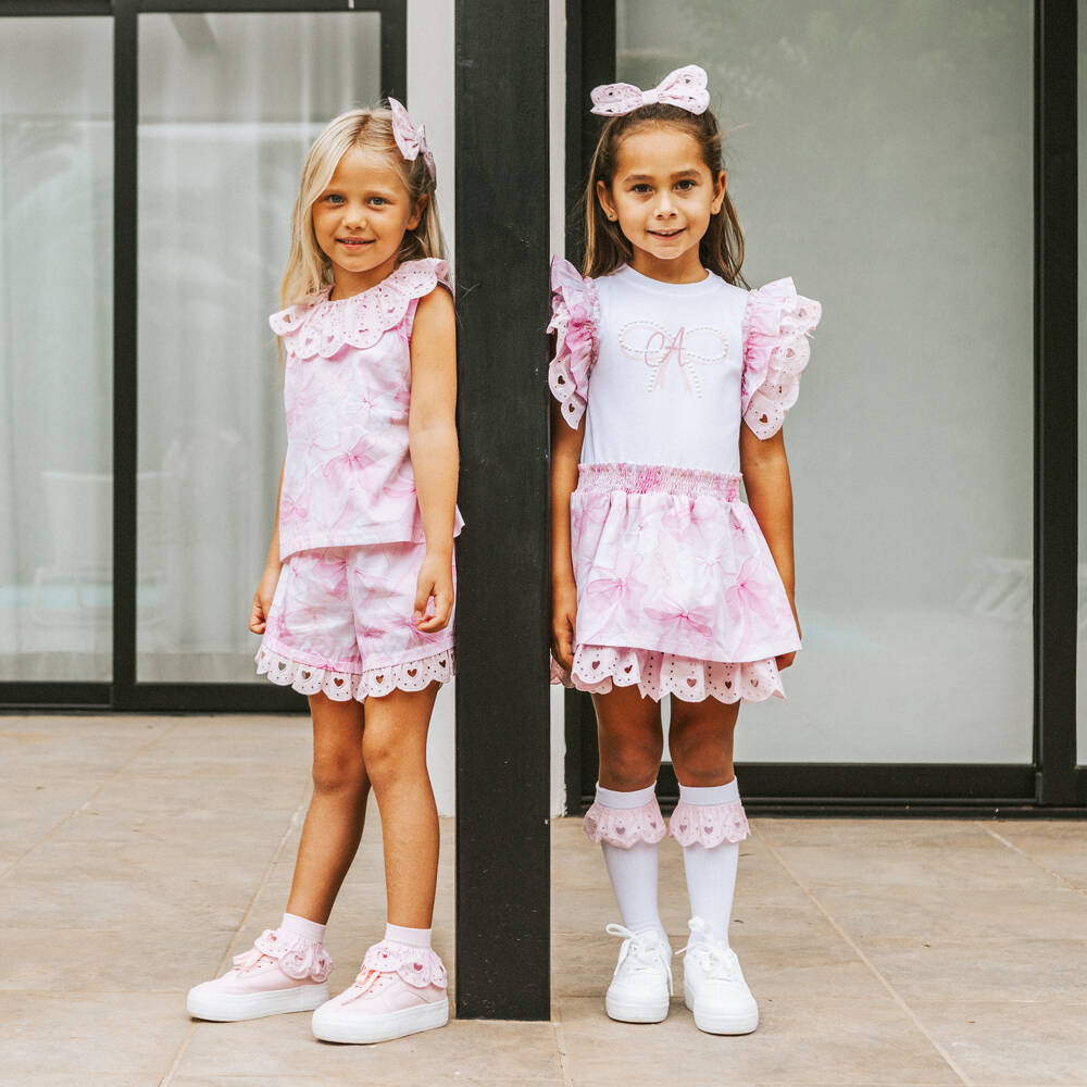 A Dee-Girls Pink Cotton Bow Dress with Broderie Anglaise Trims | Childrensalon