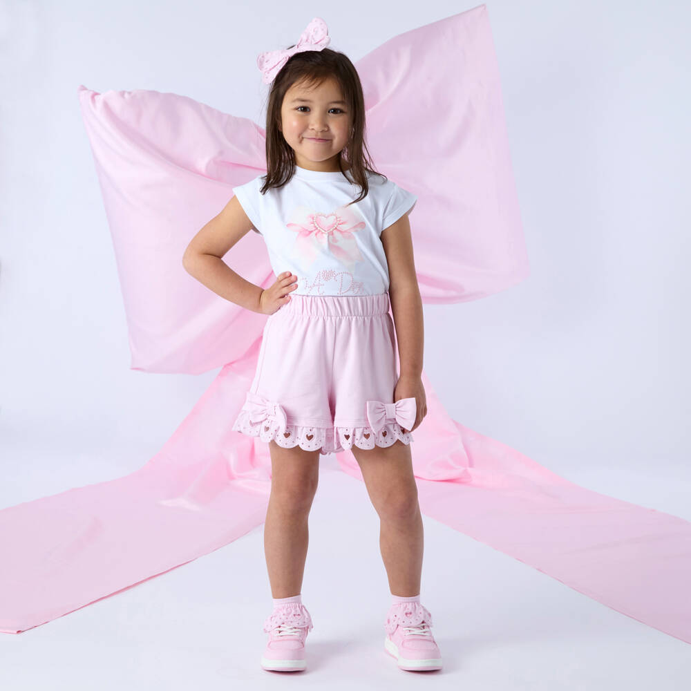 A Dee-Girls Pink Cotton Logo Shorts Set with Bows & Broderie Anglaise | Childrensalon