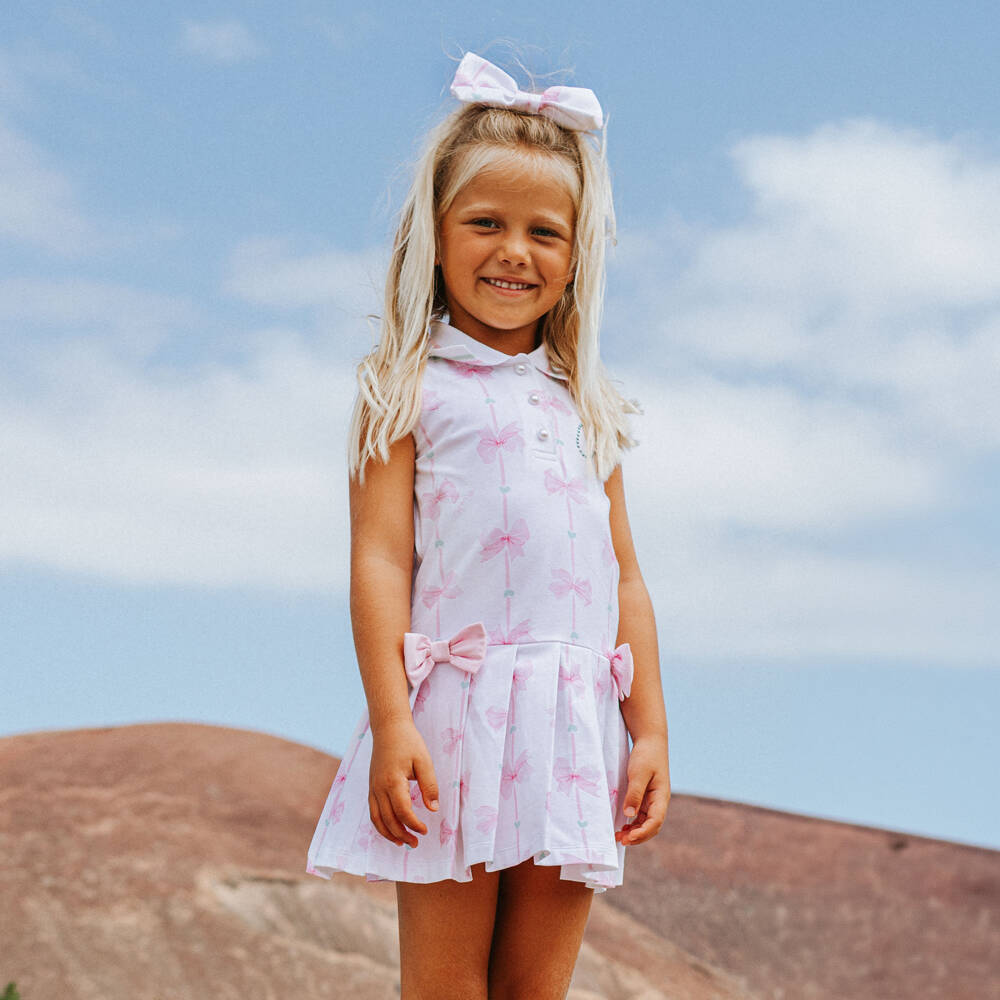A Dee-Girls White Cotton Tennis Style Dress with Pink Bows | Childrensalon