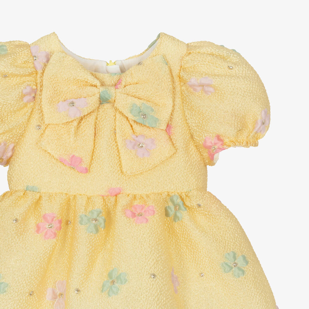 Hucklebones London-Платье жёлтое жаккардовое с цветами и бантом для малышек | Childrensalon