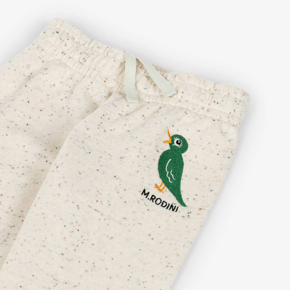Mini Rodini-Beige Organic Cotton Joggers with Embroidered Green Bird | Childrensalon