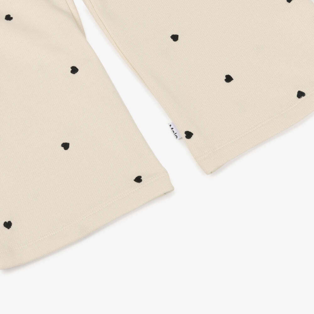 Molo-Джоггеры хлопковые кремовые с черной вышивкой сердец для девочек | Childrensalon