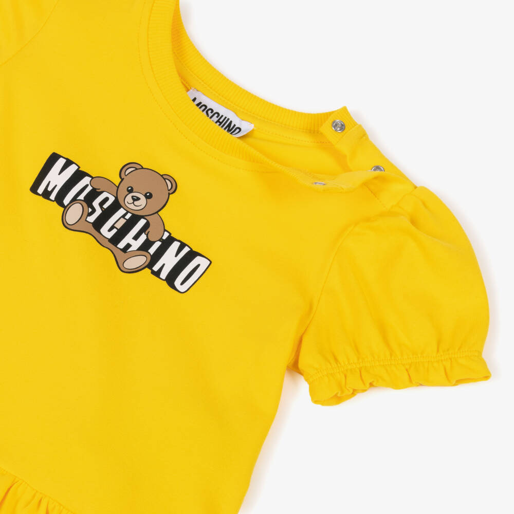 Moschino-Baby Girls Yellow Cotton Jersey Teddy Bear Logo Dress | Childrensalon