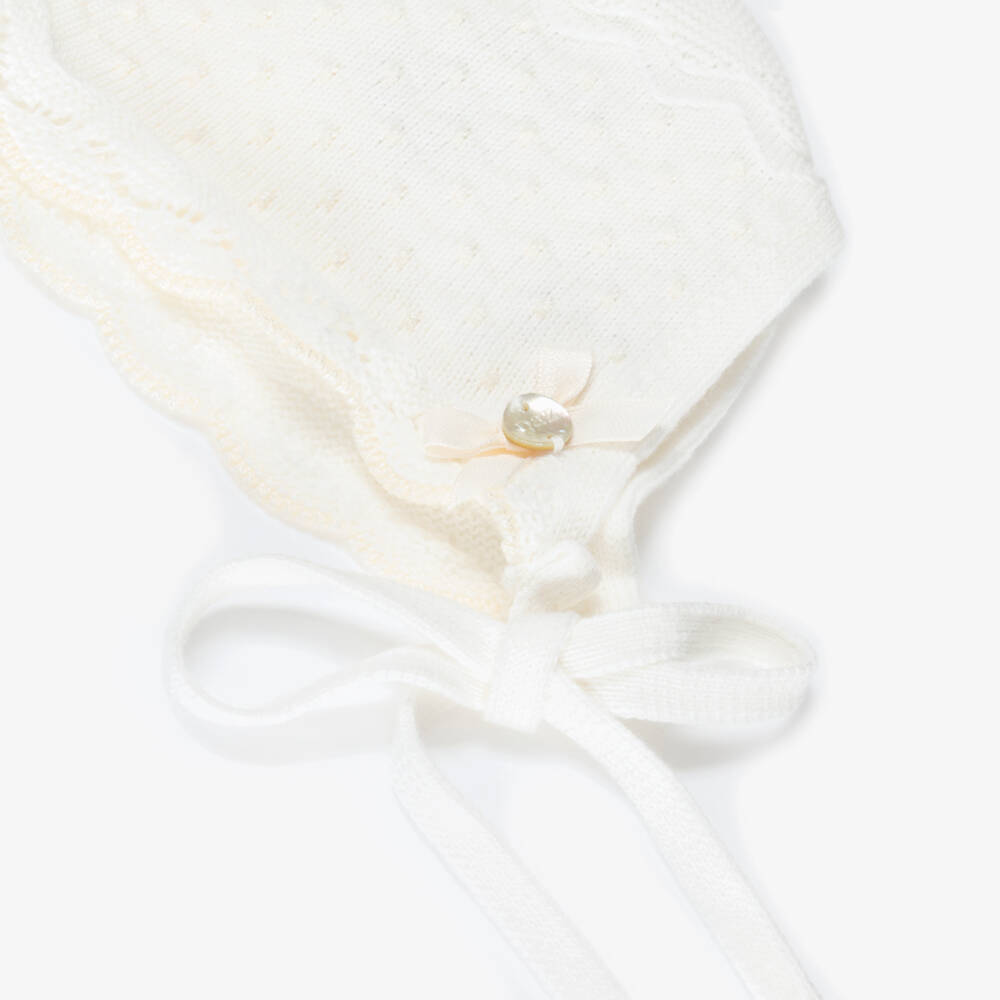 PAZ Rodríguez-Ivory Cotton Knit Baby Bonnet with Knot Stitch Detail | Childrensalon