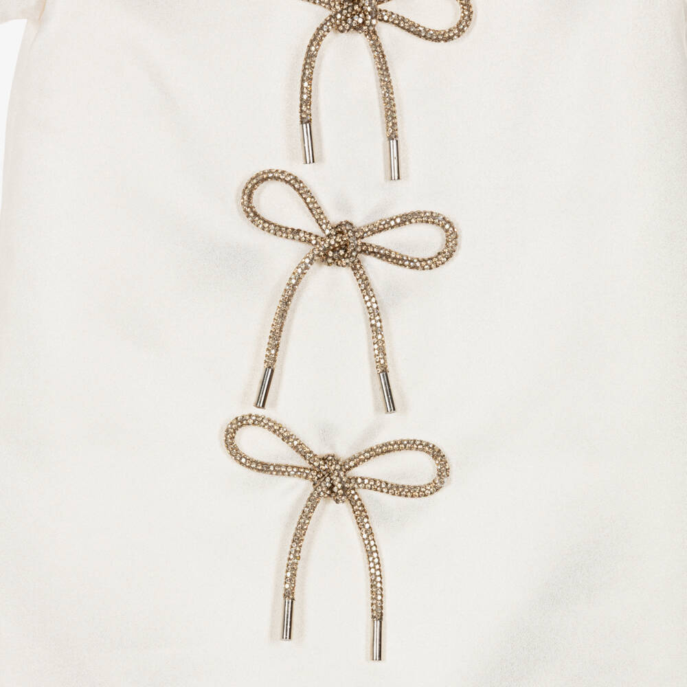 Romano-فستان مزين بفيونكات مرصعة بالكريستال لون عاجي للبنات | Childrensalon