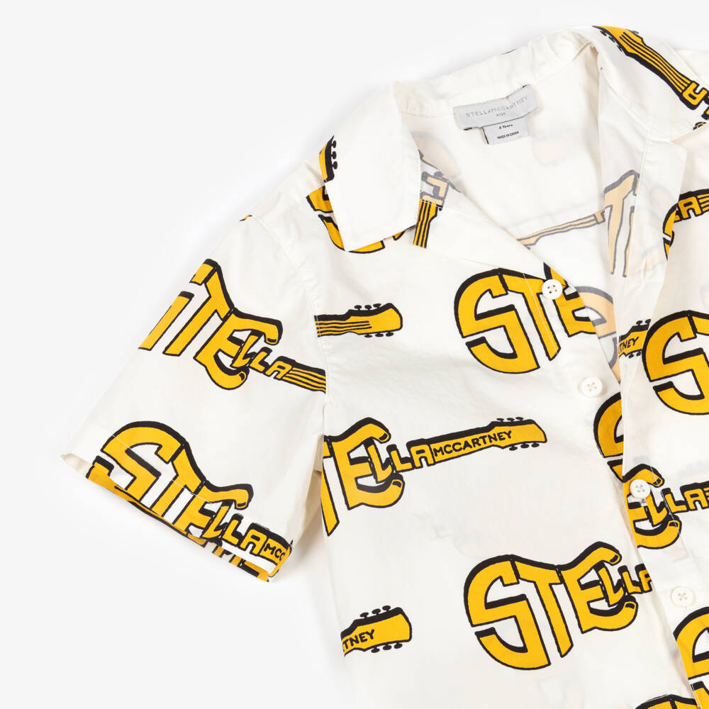 Stella McCartney Kids-قميص قطن بطبعة جيتار أصفر لون عاجي للأولاد | Childrensalon