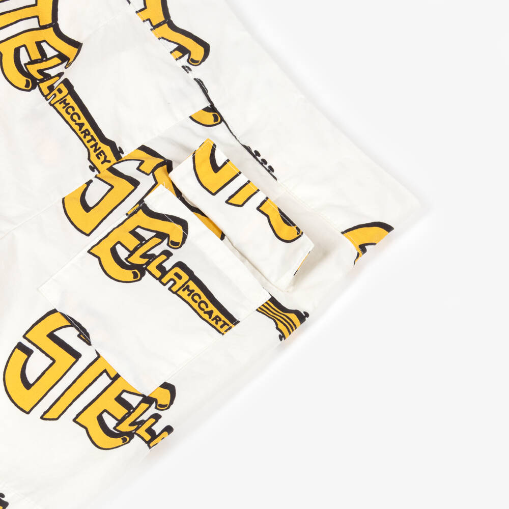 Stella McCartney Kids-Шорты кремовые хлопковые с жёлтыми гитарами для мальчиков | Childrensalon