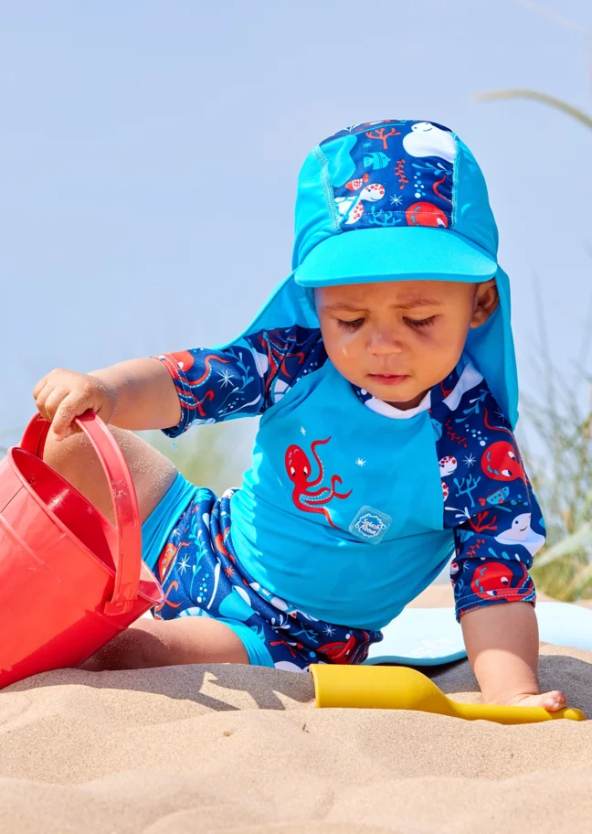 Baby boy wearing matching swimwear set for babies.